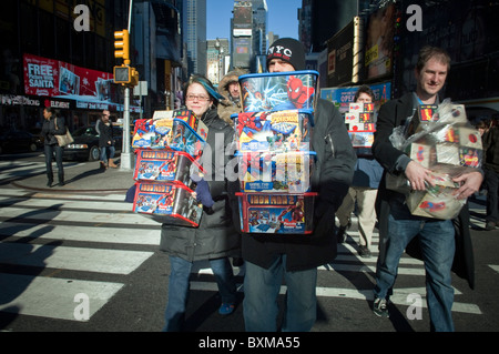 Coloro che portano i giocattoli per donare ai giochi per i più piccoli si vede in Times Square a New York Foto Stock