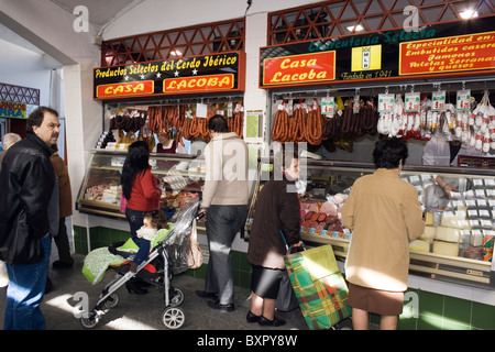 I clienti che acquistano la salsiccia piccante da uno stallo nel mercato centrale, Andujar, Jaen, Spagna. Foto Stock