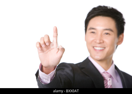 Imprenditore utilizzando il dito al punto Foto Stock