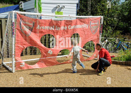 Arsenal nella Comunità, l'uomo con un giovane ragazzo in una sanzione di kick off Gillespie Park, Highbury Londra Inghilterra REGNO UNITO Foto Stock