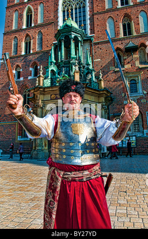 Interessante il ritratto di uomo blindato in costume con la spada nella piazza principale del mercato bella Cracovia Polonia Foto Stock