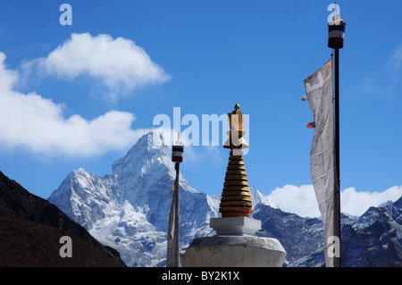 Ama Dablam con uno stupa e bandiere di preghiera nel villaggio nepalese di Khumjung Foto Stock