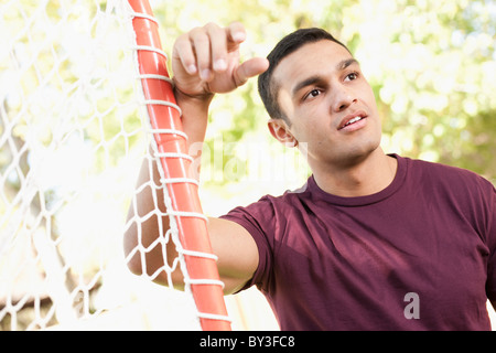 Stati Uniti d'America, Utah, giovane uomo appoggiato su goalpost Foto Stock
