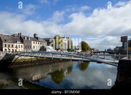 Il Millenium Bridge del piede con la Chiesa di Santa Maria, oltre il Fiume Lee, la città di Cork, Irlanda Foto Stock