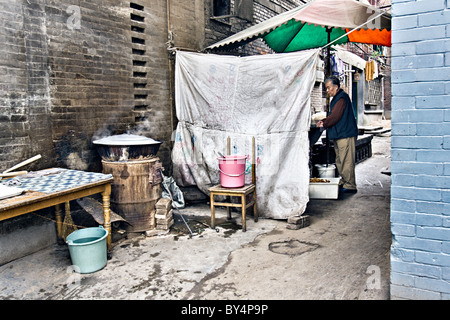 Cina, Xi'an: piccolo ristorante in un vicolo nel vecchio quartiere musulmano di Xian con un wok cottura su una canna stufa. Foto Stock