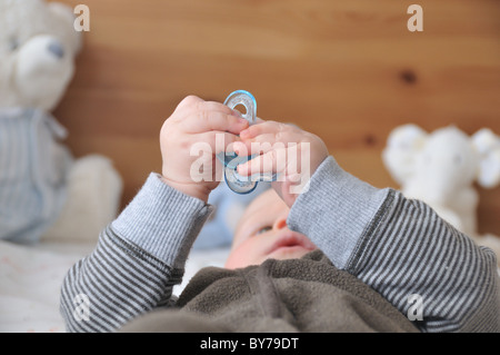 Il bambino gioca con la sua falsa Foto Stock