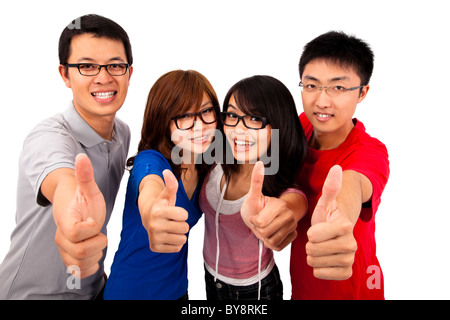 Quattro giovani adolescenti ridendo e dando il pollice in su Foto Stock