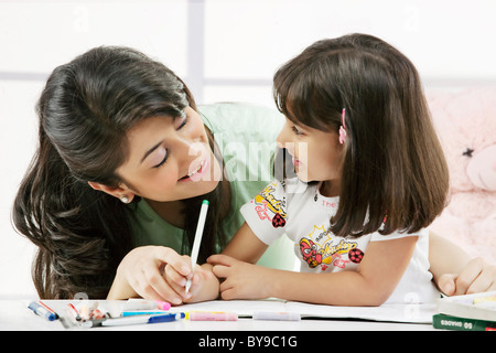 Madre e figlia con un libro da colorare Foto Stock