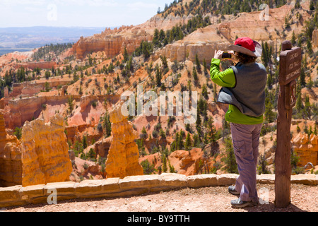 Turistica prendendo una foto del paesaggio in Bryce Canyon Foto Stock