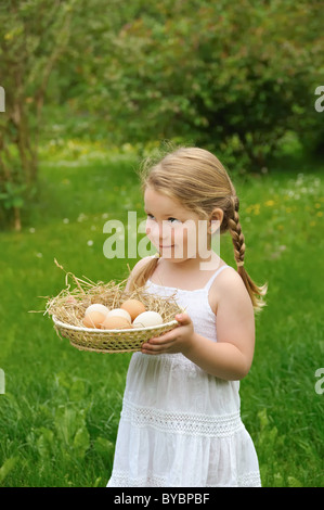 Bambina tenendo le uova fresche Foto Stock