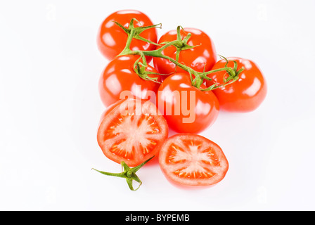 Grappolo di pomodori con due metà su sfondo bianco Foto Stock