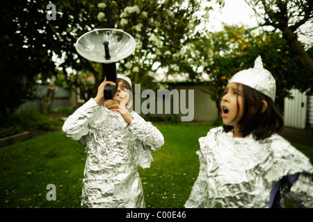 I bambini indossare la lamina di cottura pur guardando fuori per una possibile invasione aliena. Foto Stock
