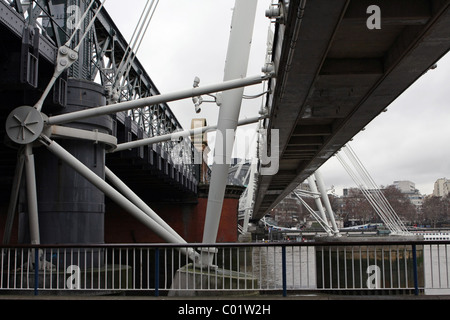 Una vista da sotto il Golden Jubilee Bridge, Londra, Inghilterra, con Hungerford ponte ferroviario sulla sinistra Foto Stock