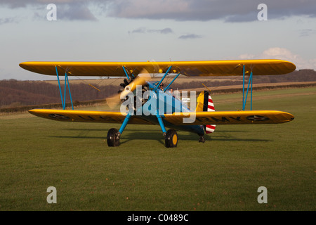 Un vintage PT13-D biplano Stearman battenti a Compton Abbas airfield in Inghilterra Foto Stock