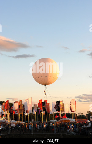 Palloncino Heliosphere e ballerino di eseguire in aria al di sopra di Womad Festival, Malmesbury, Wiltshire, Regno Unito Foto Stock