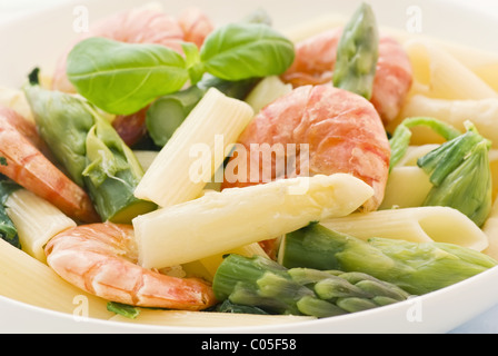 Italian tagliatelle con gamberi e asparagi spears come primo piano su una piastra bianca Foto Stock