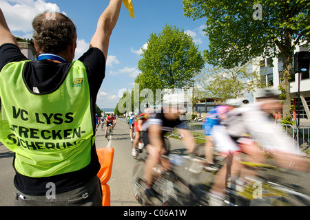 Via marshal e corridori ciclisti, motion blur, Berner Rundfahrt 2010 gara ciclistica in Lyss, Svizzera, Europa Foto Stock