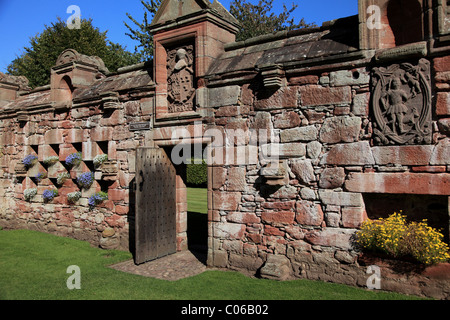 La porta del grande giardino murato al Castello Edzell, vicino Brechin, Angus, Scozia, con fioriere e pannello intagliato Foto Stock