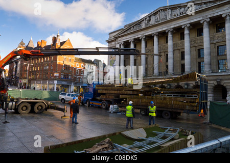 Operai lavorano con una gru e il carrello per preparare nottingham piazza del mercato per la fiera del divertimento a scuola a metà termine febbraio 2011 Foto Stock