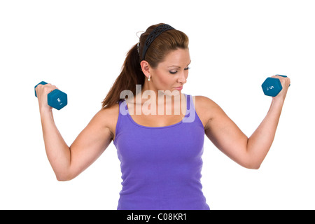 Donna usa manubri per fare resistenza peso esercizi di addestramento. Foto Stock