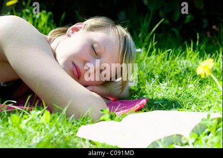 Giovane donna sdraiata su un prato, rilassante, Germania, Europa Foto Stock