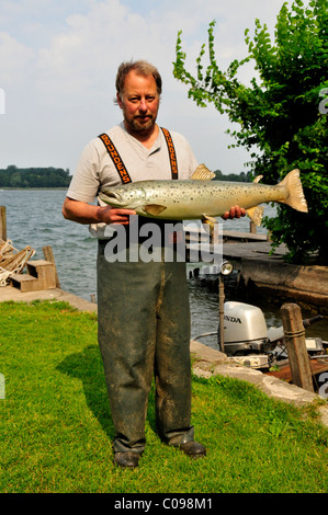 Fisherman Lex Thomas con un ripieno a base di trota marrone (Salmo trutta lacustris), isola di Fraueninsel, il lago Chiemsee, Chiemgau, Bavaria Foto Stock