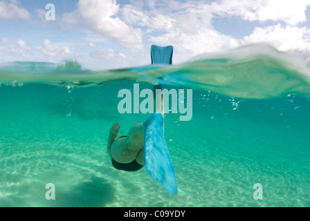 Donne di mezza età in un unico pezzo di costume da bagno snorkeling oltre sulla sabbiosa spiaggia tropicale. Ha'Gruppo apai, Tonga. Oceano Pacifico del sud. Foto Stock