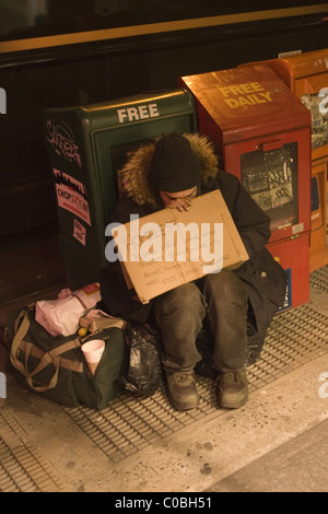 Senzatetto uomo sulla Lexington Avenue in serata a NYC. Foto Stock