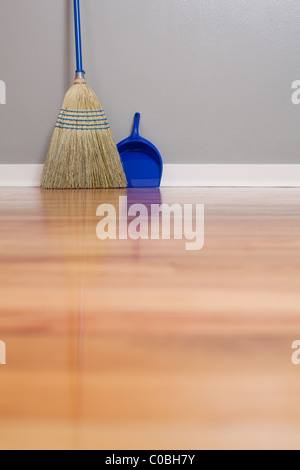 Una scopa di mais e polvere Pan su pavimenti in legno Foto Stock