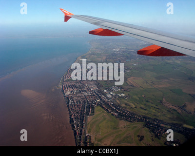 Easyjet a319 aeromobili Airbus ala guardando fuori attraverso il finestrino per aerei in giù a Wirral e liverpool bay Foto Stock