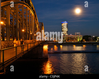 Hohenzollern ponte ferroviario a Colonia di notte, con Hyatt hotel in background. NRW, Germania Foto Stock