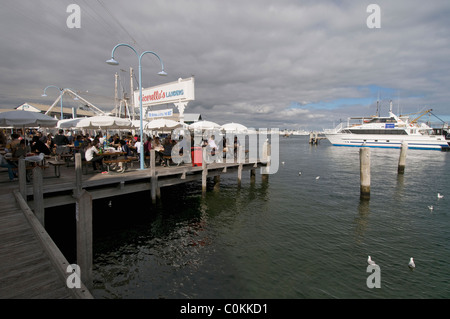 I visitatori godere il pranzo in uno dei ristoranti su un molo al Fishing Boat Harbour di Fremantle, Western Australia. Foto Stock