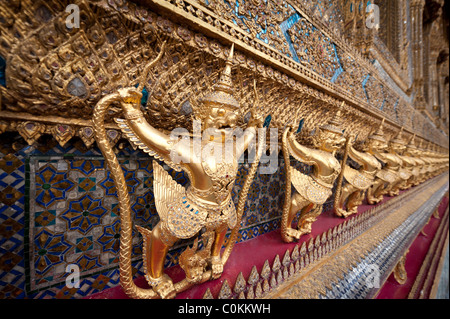 Golden Statue allineati lungo le pareti del tempio del Buddha di Smeraldo (Wat Phra Kaeo) a Bangkok, in Thailandia Foto Stock