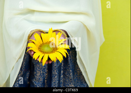 Giovane ragazza indiana holding di semi di girasole. Andhra Pradesh, India Foto Stock