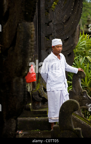 Un indù santo uomo attende adoratori presso il più importante tempio di Bali, Indonesia, Besakih o anche chiamato il Tempio madre. Foto Stock