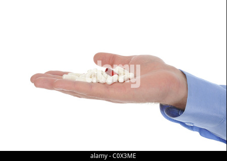 Il bianco e il rosso compresse in mano maschio Foto Stock