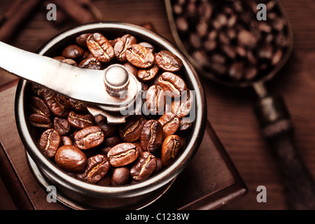 Caffè torrefatto in grani macinati in un macinino da caffè. Foto Stock