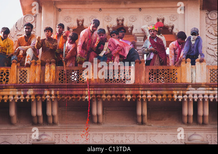 La gente celebra Holi festival in un tempio, Barsana, Uttar Pradesh, India Foto Stock