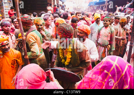 La gente celebra "listello Maar Holi festival", Barsana, Uttar Pradesh, India Foto Stock