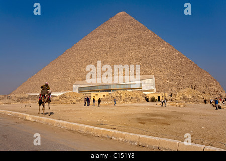 Piramide di Khufu, la Grande Piramide ( il più alto ), siede in background come la barca solare museo è in vista. Foto Stock
