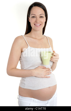 Donna incinta holding tazza di caffè / tè Foto Stock
