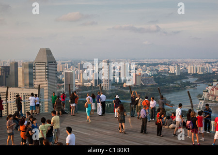 Gli ospiti si affacciano sulla skyline di Singapore dal ponte di osservazione della Marina Bay Sands SkyPark. Il Marina Bay, Singapore Foto Stock