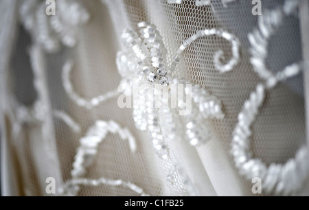 Nuziale matrimonio abito in pizzo close-up dettaglio velo di cucitura Foto Stock