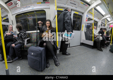 Londra, Inghilterra, Regno Unito. La gente sul tubo / treno sotterraneo Foto Stock