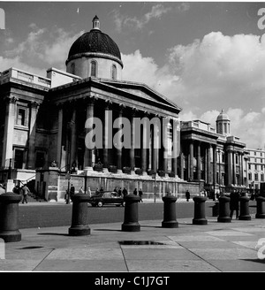 Anni '1950, ingresso colonnato coperto di fuliggine alla National Gallery, Trafalgar Square, Westminster, Londra, che mostra la strada di fronte, più tardi pedoni. Foto Stock