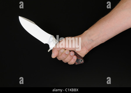 Mano che tiene il coltello Foto Stock