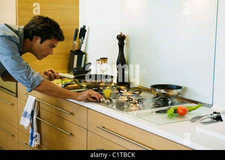 L'uomo la cottura su fornelli a gas Foto Stock