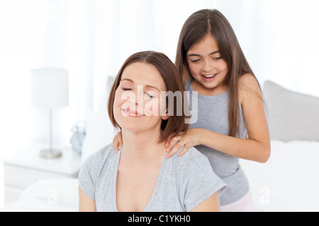 Bella figlia spazzolando la madre Foto Stock