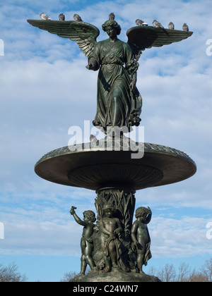 Angelo di acque statua in cima Bethesda Fontana nel parco centrale con piccioni arroccato sulle sue ali in una fredda giornata invernale e Foto Stock