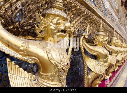 Fila di statue di Garuda sull'esterno del Tempio del Buddha di Smeraldo o Wat Phra Kaew, il Grand Palace, Bangkok, Thailandia Foto Stock